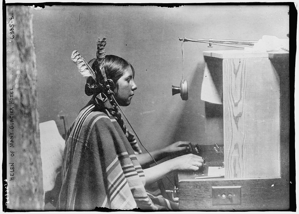 Telephone switchboard operator at work, circa 1925 — representative of the female operators who staffed Bell System exchanges like the Bowie exchange during the 'Sarah' legend era