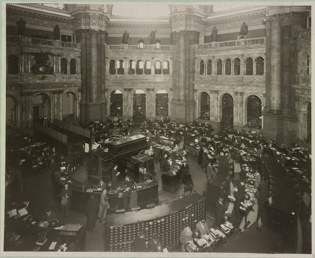 Librarians and patrons in the circular main reading room of the Library of Congress, Washington D.C., circa 1920