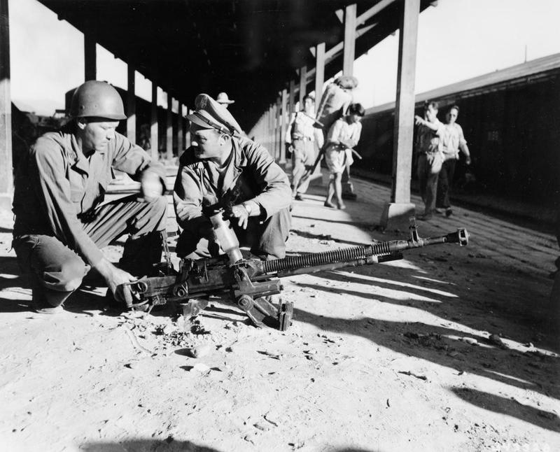 Two American soldiers examine a captured Soviet DShK machine gun near Chunju, Korea, 1950–1953