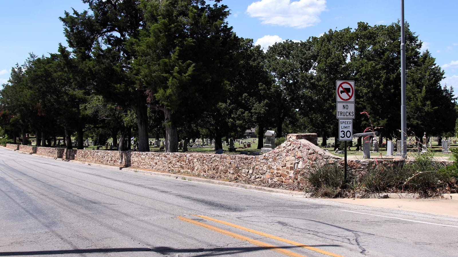 Elmwood Cemetery in Bowie, Texas — a broad view of the municipal burial ground with grave markers across open grounds