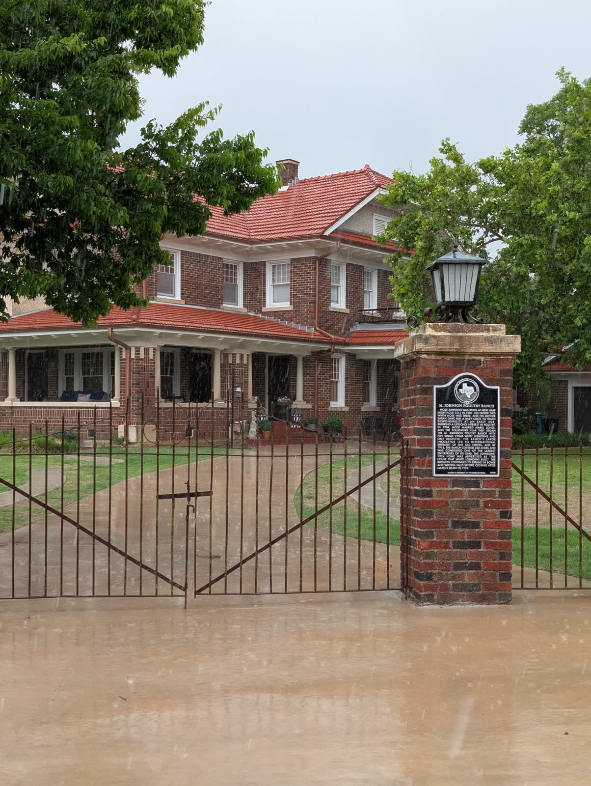 The 1924 M. Johnson Poultry Ranch house in Bowie, Texas, with the Texas Historical Commission marker on the brick gate pillar